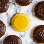 Homemade Jaffa Cakes - A British classic. Biscuit sized cakes topped with an orange jelly and sealed with dark chocolate!