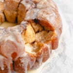 Slightly pulled-apart Monkey Bread piece revealing the soft, cinnamon-sugar interior of the dough.