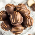 Overhead shot of a small glass bowl filled with peanut butter truffles.