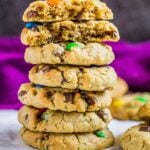 Stack of monster cookies with the top cookie broken in half.