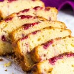 Overlapped slices of raspberry swirl lemon pound cake on parchment paper.
