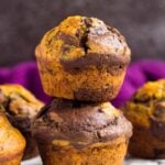 A stack of two pumpkin chocolate muffins.