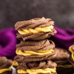 A stack of chocolate pumpkin Viennese whirls.