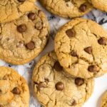 Overhead shot of chocolate chip Biscoff cookies on marble background.