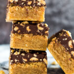 A stack of chocolate topped peanut butter blondies.