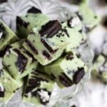 Overhead shot of mint chocolate Oreo fudge pieces in a small glass bowl.