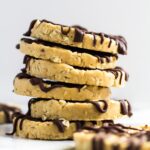 A stack of no-bake peanut butter cookies drizzled with chocolate.
