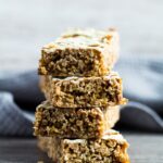 A sideview shot of Hot Cross Bun Spiced Flapjacks stacked on top of each other.