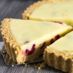 White Chocolate Raspberry Tart with slice being taken.